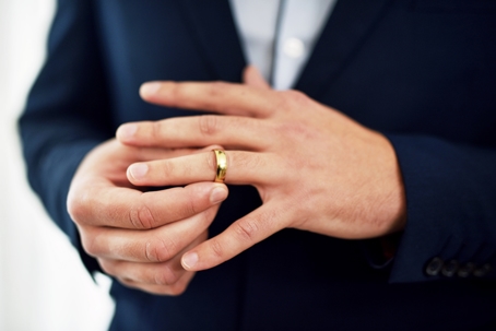businessman taking off wedding ring