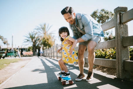 father and daughter playing outside