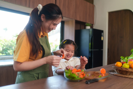 mother and daughter preparing vegetables in the kitchen