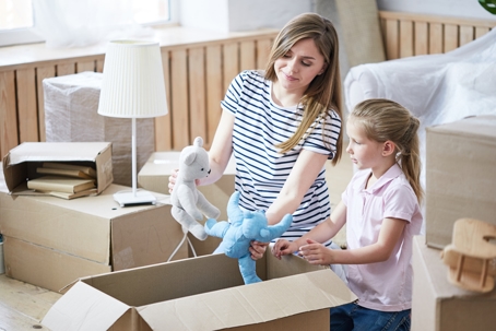 mother and daughter packing up boxes